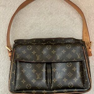 Authentic Louis Vuitton shoulder bag with 2 pocket flap front. New 12” x 9”